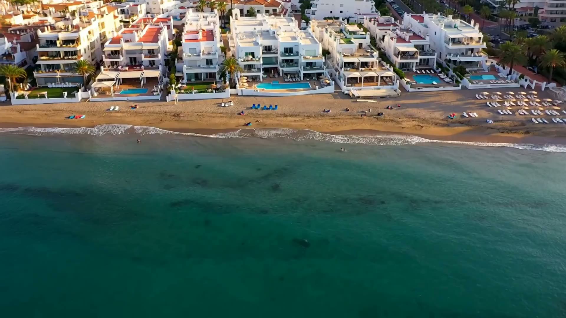 Aerial view of the Costa del Sol coastline with turquoise sea and beachfront homes